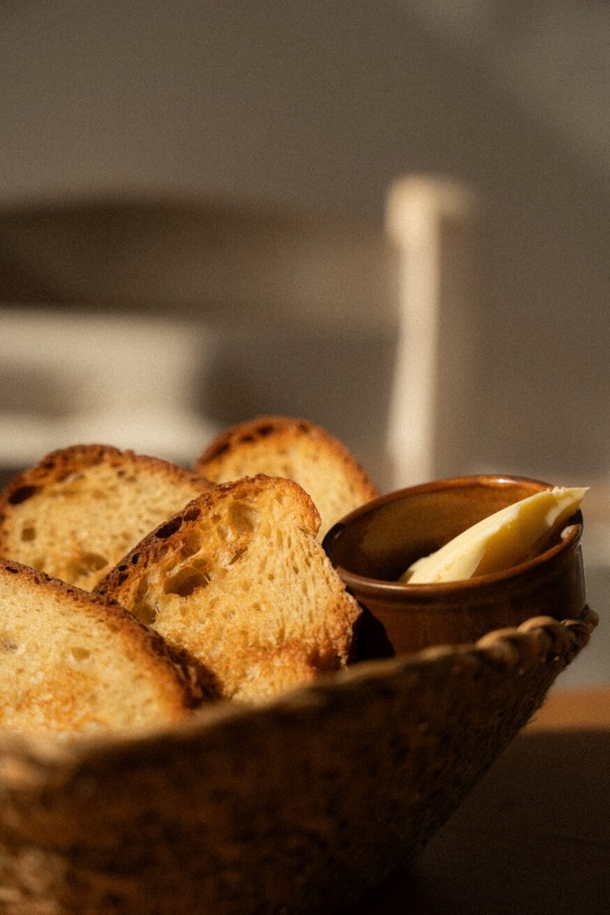 Artisanal sourdough bread basket with butter at Mykonos Brunch Club Mykonos