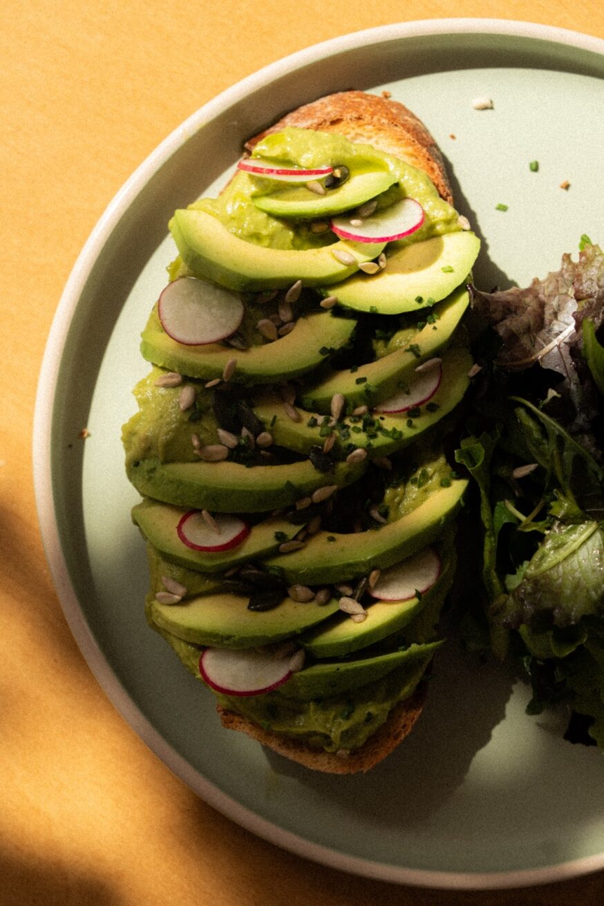 Avocado toast on artisanal sourdough with radish and seeds at Mykonos Brunch Club
