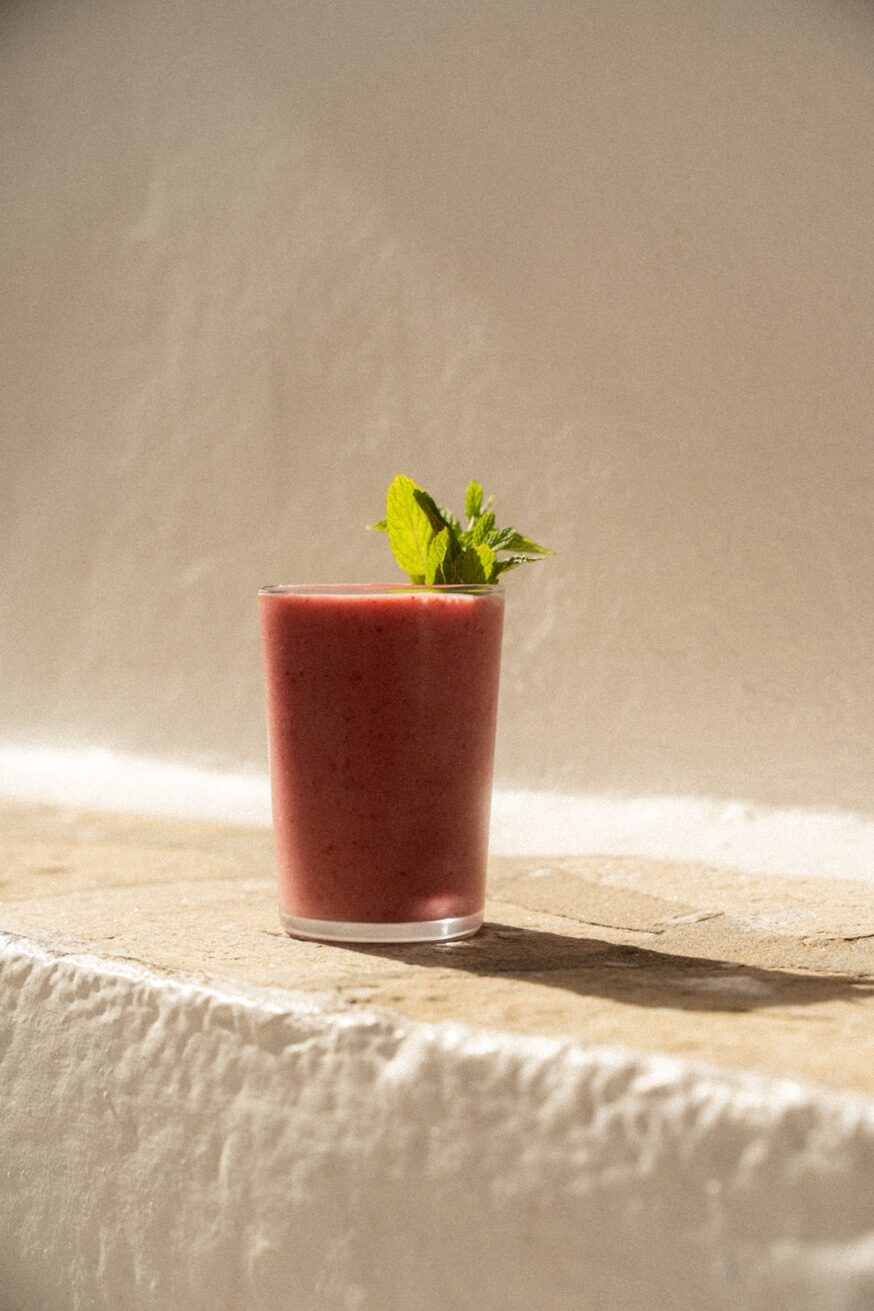 Fresh berry smoothie with mint on Mykonos cobblestones at Mykonos Brunch Club