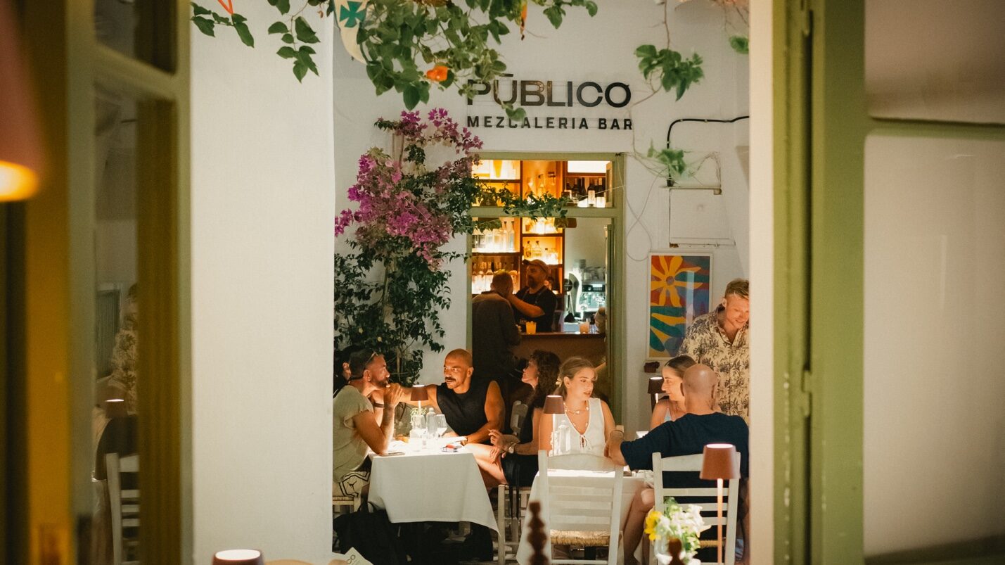 Pūblico Restaurant and Mezcaleria at night in Mykonos Town — evening terrace with guests